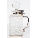 An Edwardian single bottle tantalus, the square section cut glass decanter with silver plated mount,