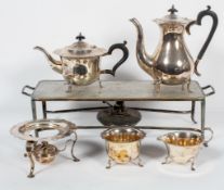 An Edwardian EPNS four piece tea service with burner, each with wavy shaped rim,