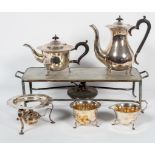 An Edwardian EPNS four piece tea service with burner, each with wavy shaped rim,