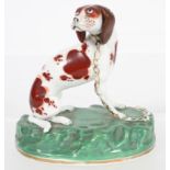 A mid 19th century Rockingham porcelain model of a hound,