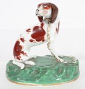 A mid 19th century Rockingham porcelain model of a hound,