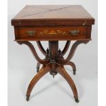 An Edwardian rosewood and inlaid envelope games table, with baize lined surface, coin hollows,