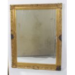 A gilt framed wall mirror, the rectangular bevelled plate inside a foliate moulded frame,