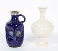 A Doulton Lambeth stoneware vase, late 19th century, with panels of scrolling decoration in relief,