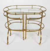 A vintage French brass and glass mounted drinks trolley, of arched rectangular form,