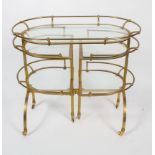 A vintage French brass and glass mounted drinks trolley, of arched rectangular form,