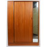 An Austinsuite style teak wardrobe with sliding door and fixed dressing mirror,