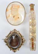 A Victorian pinchbeck revolving mourning brooch, inset a lock of hair, in scrolled frame, 5.2cm x 4.