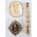A Victorian pinchbeck revolving mourning brooch, inset a lock of hair, in scrolled frame, 5.2cm x 4.