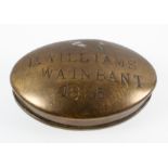 A Victorian brass snuff box and cover, of oval form, stamped D Williams/ Wainbant/1885,