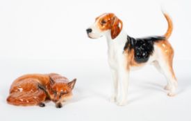 A Royal Doulton hound ?HN2585?, standing four square, painted marks, 18cm long; and a Beswick fox,