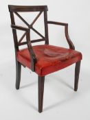 A Regency mahogany armchair, the curved top rail above reeded cross back with central roundel,