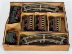 An early 20th century A W Gamage Ltd, '0' gauge clockwork train set, in original box,