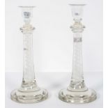 A pair of enamel tourist glass candlesticks with a central helix inside a double spiral,