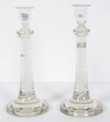 A pair of enamel tourist glass candlesticks with a central helix inside a double spiral,