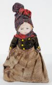 A bisque doll, probably French, the jointed body in 19th century costume,