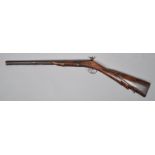 A 19th century Indian Percussion Carbine rifle, the stock carved with foliate motifs,