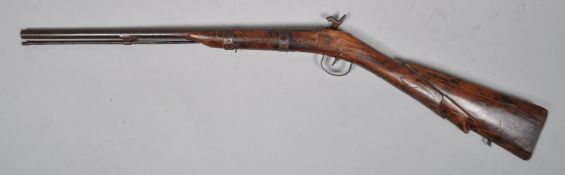 A 19th century Indian Percussion Carbine rifle, the stock carved with foliate motifs,