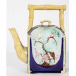 A late 19th century aesthetic movement Majolica teapot with simulated bamboo handle and spout,