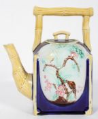 A late 19th century aesthetic movement Majolica teapot with simulated bamboo handle and spout,