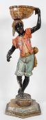 A Venetian style carved wood and gesso Blackamoor, the boy standing with a gilt basket on his head,