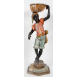 A Venetian style carved wood and gesso Blackamoor, the boy standing with a gilt basket on his head,