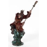 A cold painted bronze of a monkey warrior, 20th century, cast astride a high wave, holding an axe,