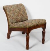 A late 19th century upholstered oak gout stool, with ring turned forelegs,