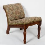 A late 19th century upholstered oak gout stool, with ring turned forelegs,