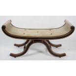 A Regency style oak and ebonised window seat, late 19th century, the scrolling seat on arched legs,