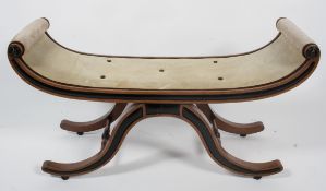 A Regency style oak and ebonised window seat, late 19th century, the scrolling seat on arched legs,