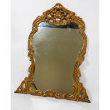 A large late 20th century carved gilt wood mirror, of rococo form,