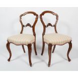 A pair of late 19th century walnut balloon back side chairs,