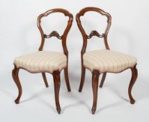 A pair of late 19th century walnut balloon back side chairs,