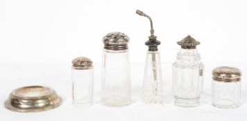 A panel cut glass dressing table jar with a stamped silver lid, decorated with cabochons and leaves,