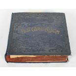 A large Edwardian postcard album, mounted with assorted images of artwork, sculpture,