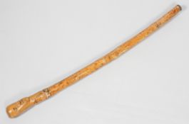 A 20th century naively carved hardwood African walking stick/cudgel, the grip modelled as a head,