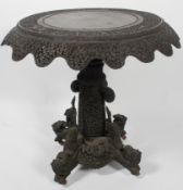 An Anglo-Indian carved hardwood table, 19th century, the circular top densely carved with animals,