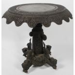 An Anglo-Indian carved hardwood table, 19th century, the circular top densely carved with animals,