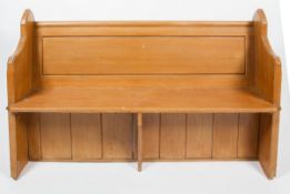 A stained pine Church style pew/bench, with arched side panels and moulded and panelled back rest,