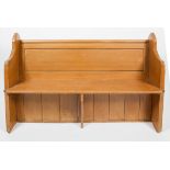 A stained pine Church style pew/bench, with arched side panels and moulded and panelled back rest,