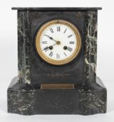 A Victorian black slate and marble mantle clock, applied with a brass presentation plaque,