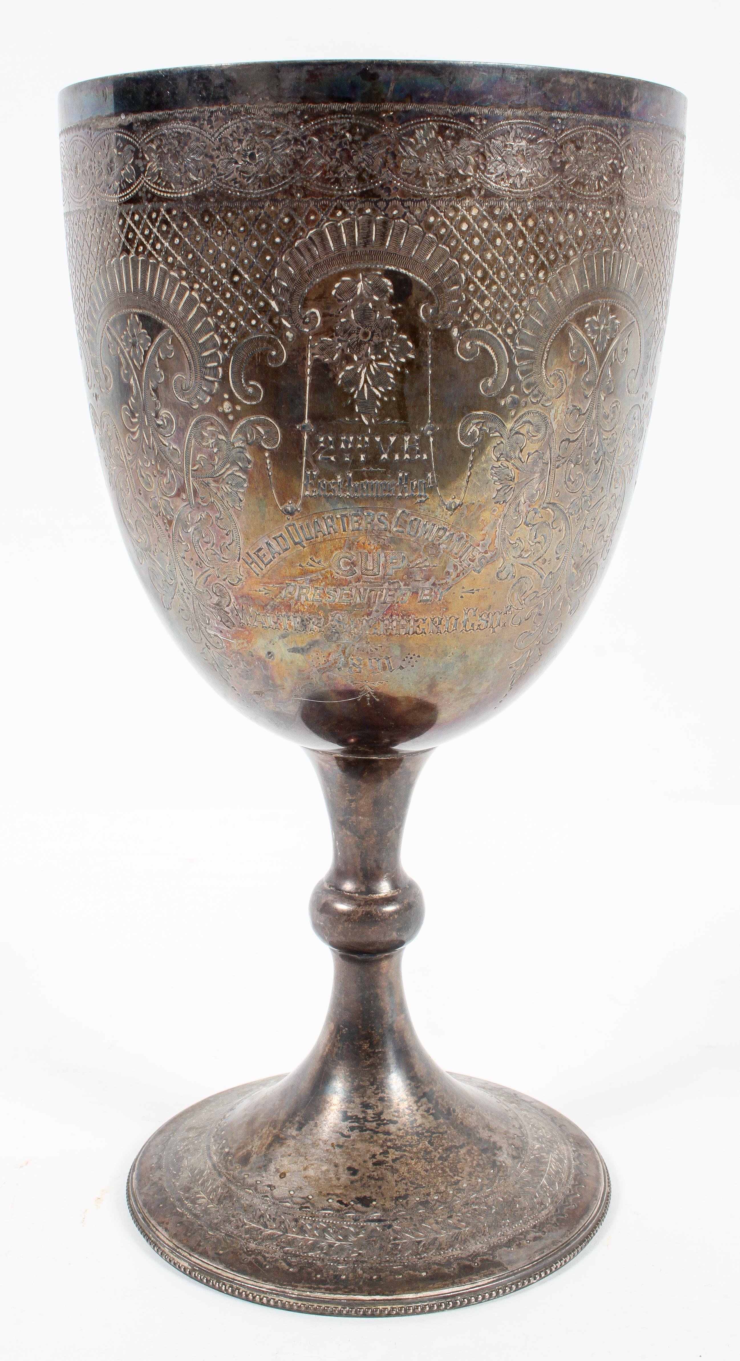 A large silver Chalice style trophy, engraved with panels of foliate strapwork to the bowl,