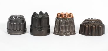 Four Victorian metal jelly moulds, including a castle shaped example (stamped C/393),