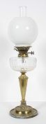 A Victorian brass and glass oil lamp, with clear chimney and opaque globe shade,