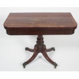 A Regency mahogany folding games table, the D-shaped cross-banded top revealing a red baize,