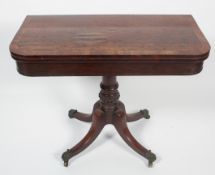 A Regency mahogany folding games table, the D-shaped cross-banded top revealing a red baize,
