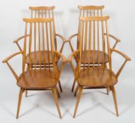 Four Ercol pale beech stick back kitchen armchairs, each with curved top rail and arms,