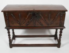 An oak chest on stand, the chest late 17th century, the base possibly later,