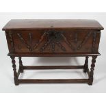 An oak chest on stand, the chest late 17th century, the base possibly later,